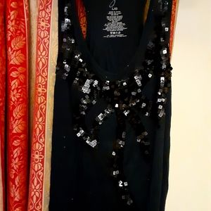 Variety of ladies shirts and skirts.